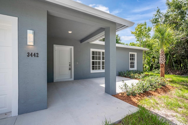 entrance to property with a patio