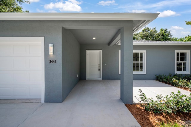 doorway to property with a garage