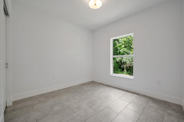 unfurnished room with light tile patterned floors