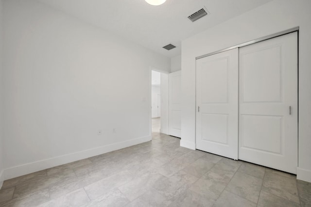 unfurnished bedroom with a closet and light tile patterned floors