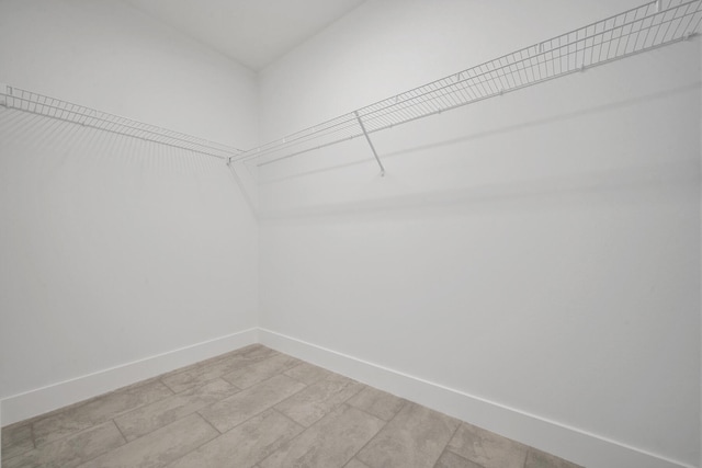 spacious closet with light tile patterned flooring