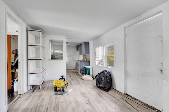 entryway featuring light wood-style flooring and baseboards