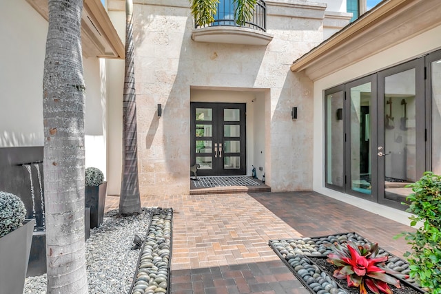 view of exterior entry featuring french doors