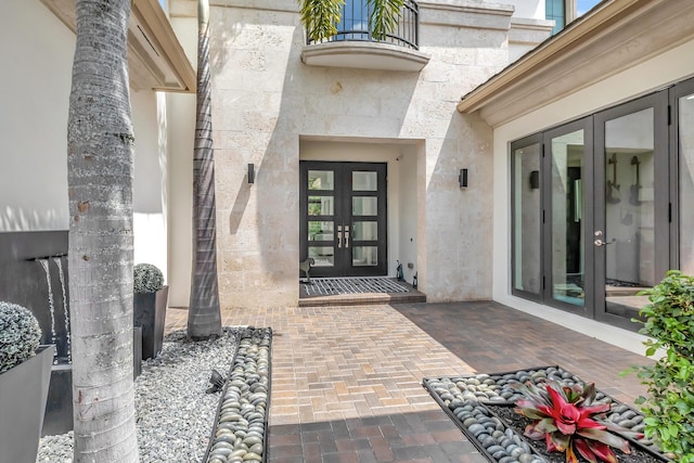 property entrance featuring a patio and french doors