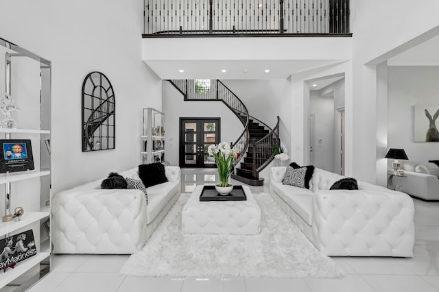 tiled living room featuring french doors and a towering ceiling