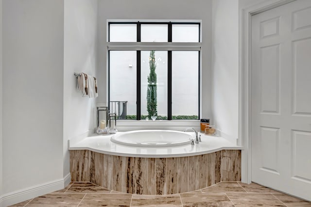 bathroom with a bath, tile patterned flooring, and plenty of natural light