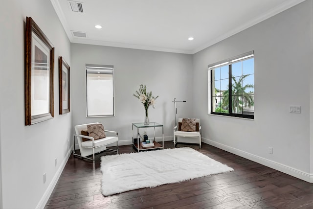 sitting room with dark hardwood / wood-style floors and ornamental molding