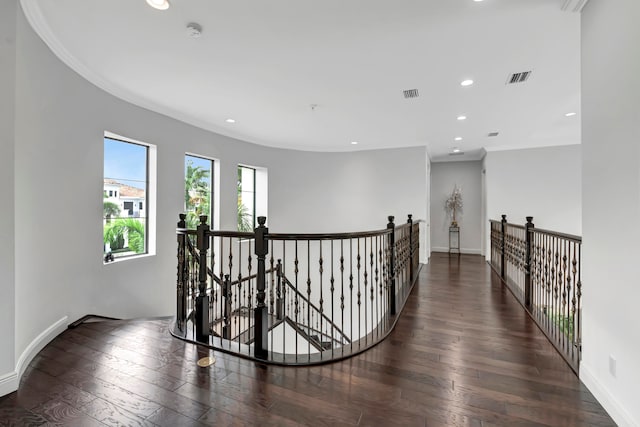 hall featuring dark hardwood / wood-style flooring and crown molding