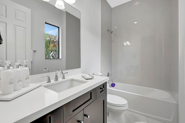 full bathroom with tiled shower / bath combo, toilet, and vanity