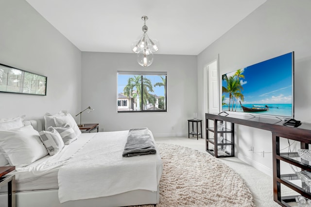 bedroom featuring light colored carpet and an inviting chandelier