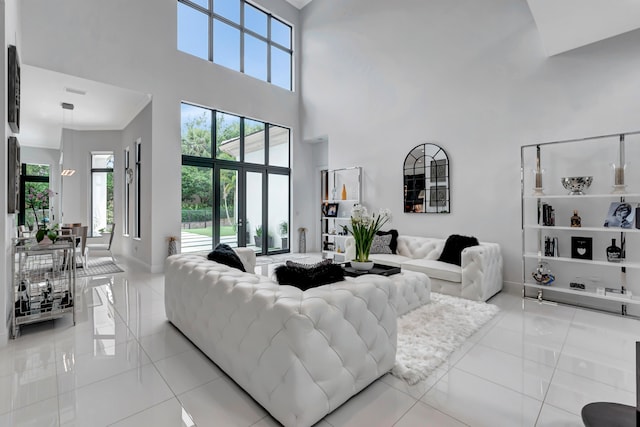 living room featuring light tile patterned floors and a towering ceiling