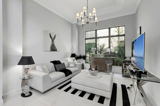 living room with an inviting chandelier, tile patterned floors, and a raised ceiling