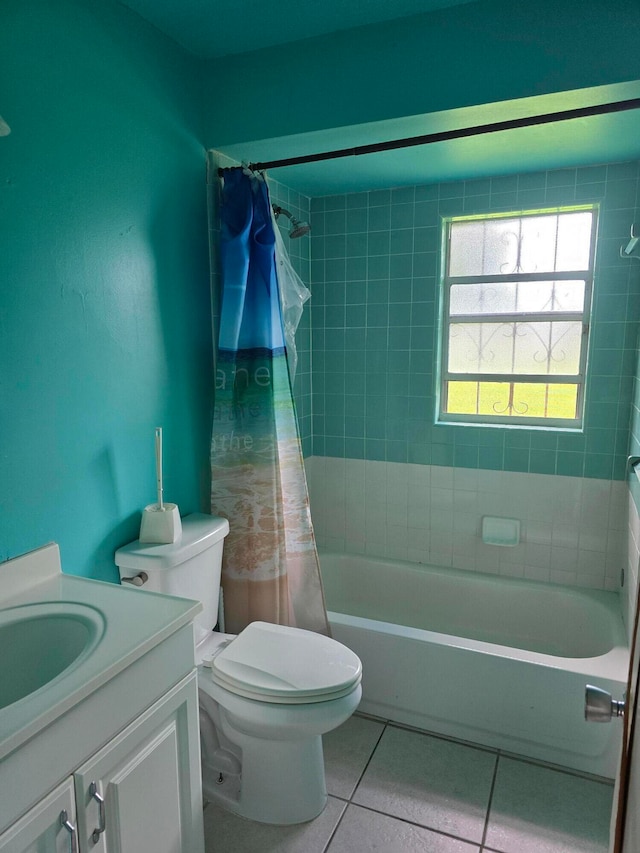 full bathroom with tile patterned floors, shower / bath combo with shower curtain, vanity, and toilet