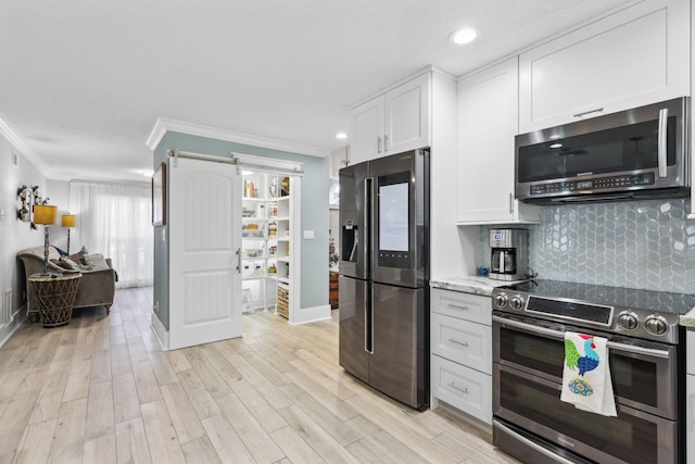 kitchen featuring tasteful backsplash, appliances with stainless steel finishes, white cabinets, and crown molding