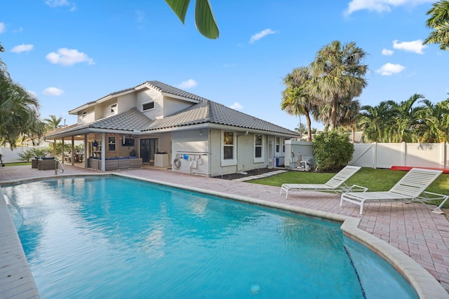 view of swimming pool with a fenced backyard, outdoor lounge area, a fenced in pool, and a patio