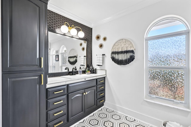 bathroom featuring baseboards, ornamental molding, tile patterned flooring, and vanity