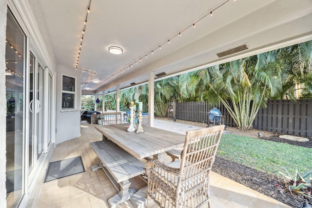 view of patio / terrace featuring outdoor dining area and fence