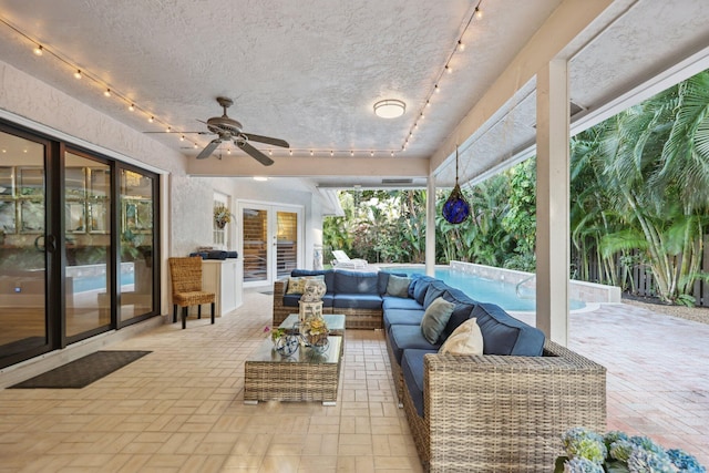 view of patio featuring an outdoor pool, ceiling fan, an outdoor living space, and french doors