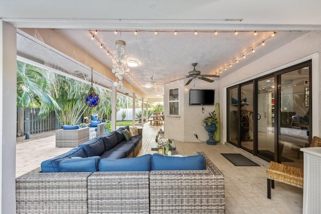 view of patio / terrace with ceiling fan, fence, and an outdoor hangout area