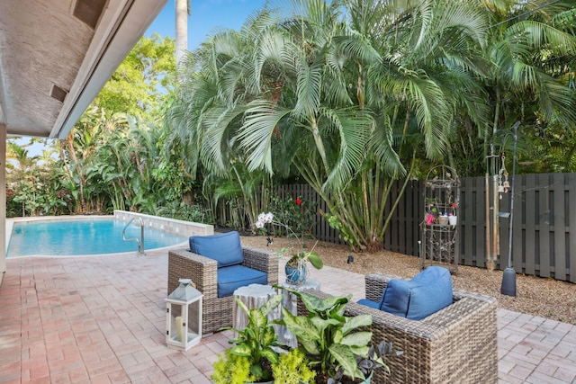 view of swimming pool with a fenced in pool, a patio area, and outdoor lounge area