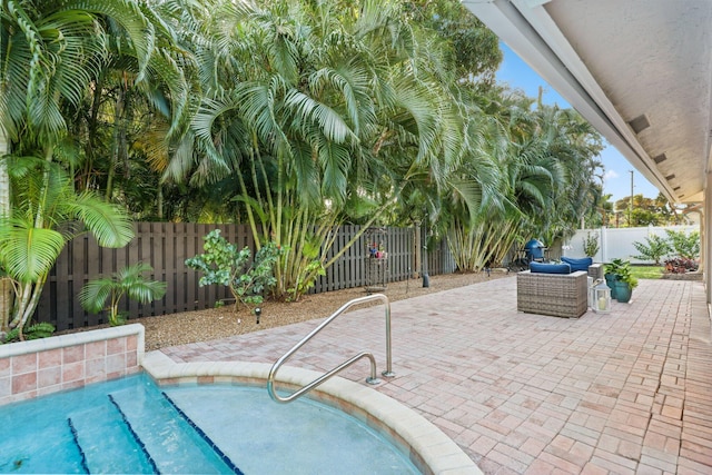 view of swimming pool featuring a fenced backyard, outdoor lounge area, a fenced in pool, and a patio