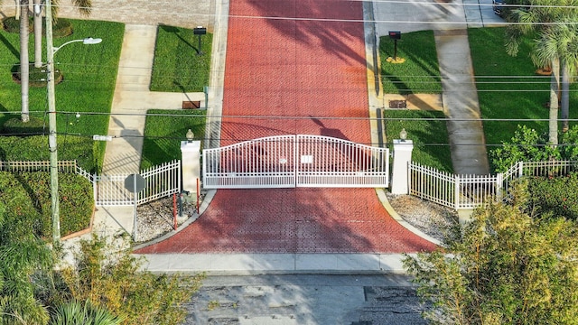 view of gate with a fenced front yard