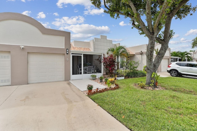 view of front of house with a garage and a front lawn