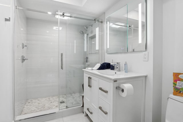 bathroom featuring tile patterned floors, vanity, toilet, and an enclosed shower