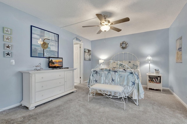 bedroom with light carpet, ceiling fan, and a textured ceiling