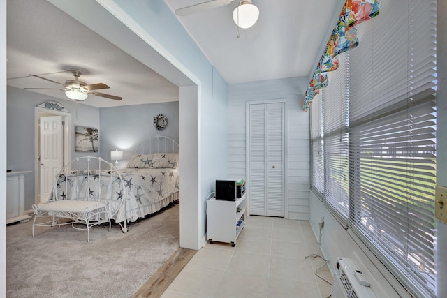 tiled bedroom with a closet and ceiling fan