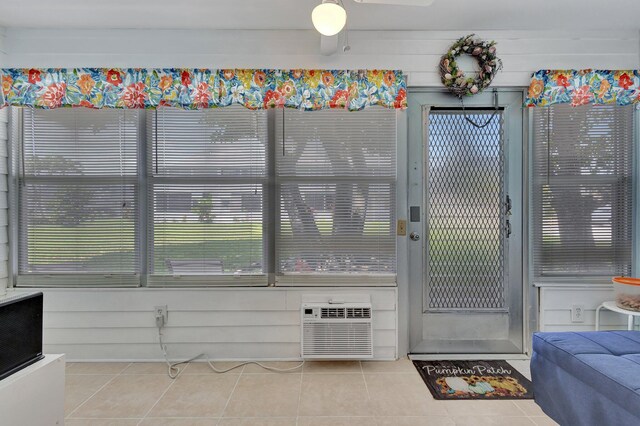 interior space featuring a wall unit AC and ceiling fan