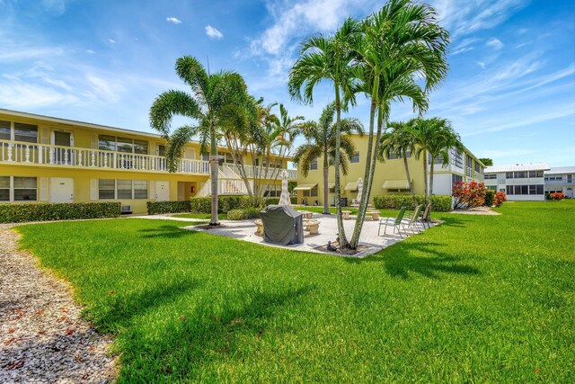 view of property's community with a patio and a yard