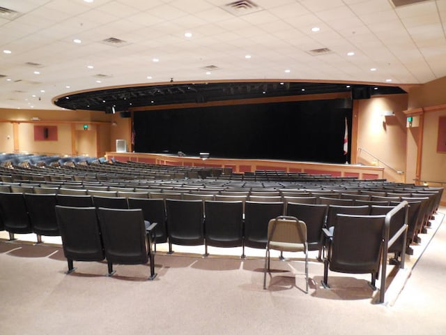 home theater with a drop ceiling and light colored carpet