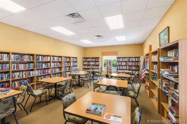 carpeted office featuring a drop ceiling