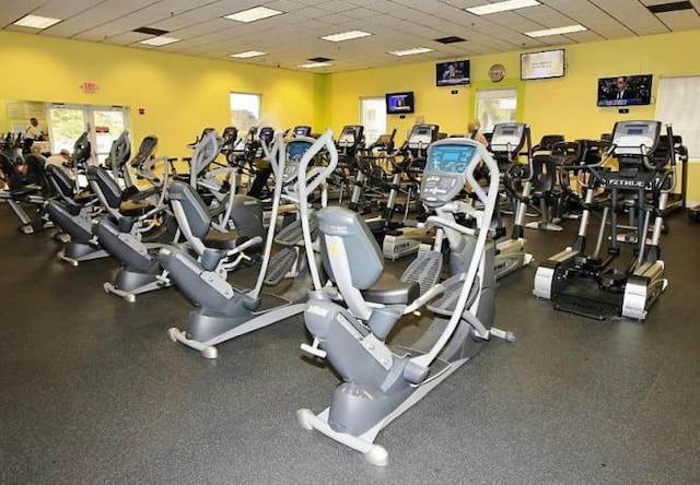 gym with a paneled ceiling