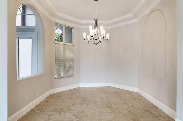 empty room featuring a chandelier and ornamental molding