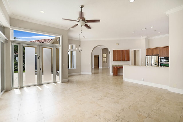 unfurnished living room featuring ceiling fan, plenty of natural light, and crown molding