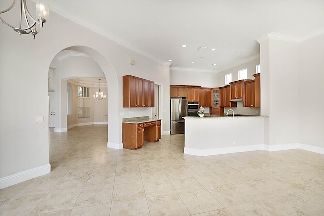 kitchen featuring stainless steel appliances, an inviting chandelier, kitchen peninsula, light stone counters, and crown molding