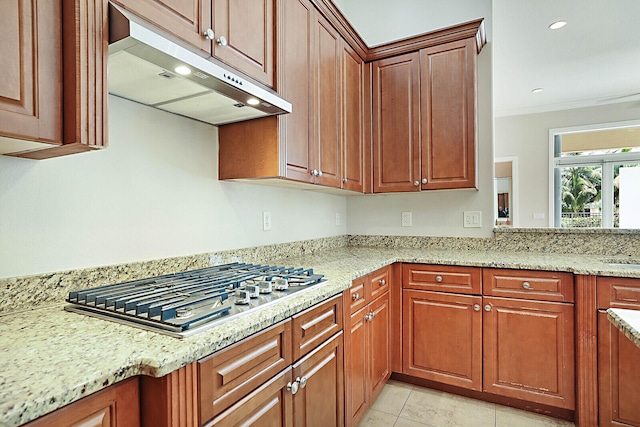 kitchen featuring light stone counters, crown molding, stainless steel gas cooktop, and light tile patterned flooring