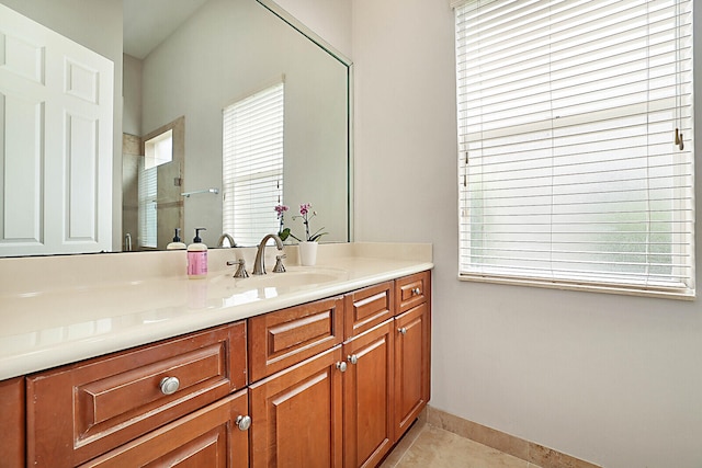 bathroom with vanity, tile patterned floors, plenty of natural light, and a shower with door