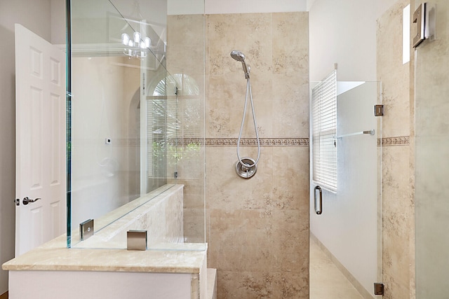 bathroom with a shower with door