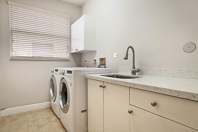 laundry area featuring cabinets, sink, and washer and dryer