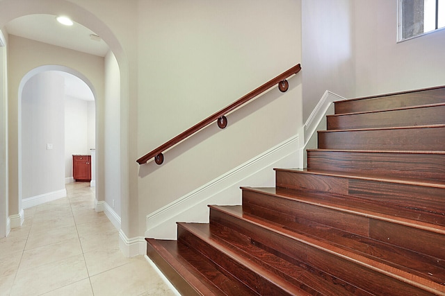 stairway with tile patterned floors