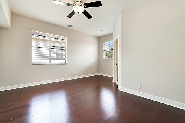 spare room featuring ceiling fan and dark hardwood / wood-style floors