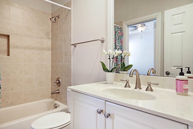 full bathroom featuring toilet, shower / bath combination with curtain, and vanity