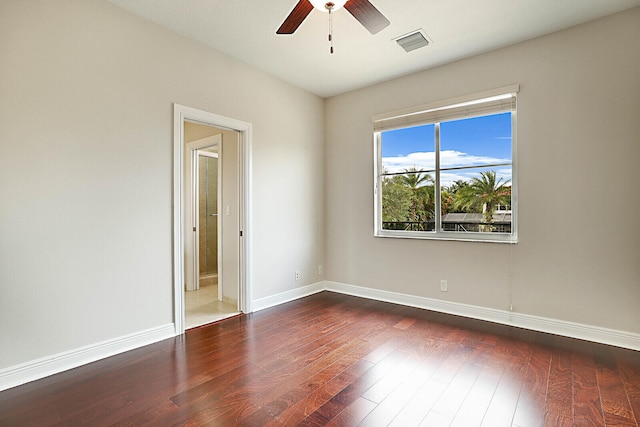 spare room featuring ceiling fan and dark hardwood / wood-style flooring