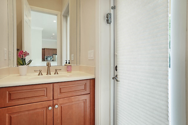 bathroom featuring vanity and crown molding