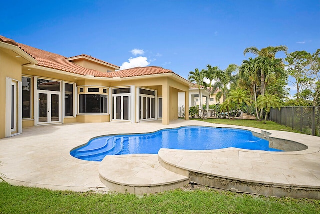 view of pool with french doors and a patio area