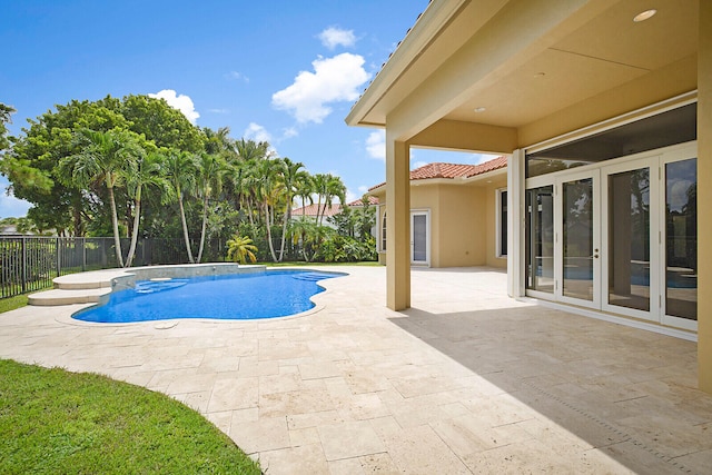 view of pool with french doors and a patio area