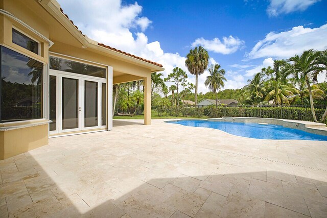 view of pool with a patio area and french doors